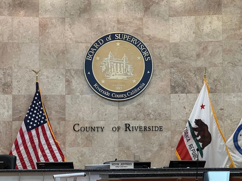 A photo of the dais inside the Riverside County Board of Supervisors meeting room.