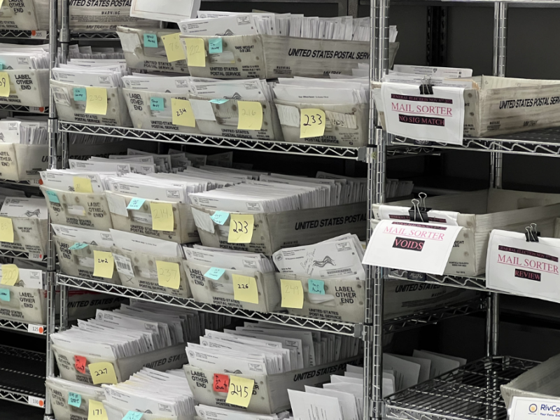 Racks of mail-in ballot envelopes that could not be counted.