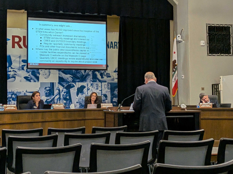 A man presenting a slide show to the school board