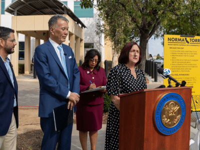 Elected officials holding a press conference outside the Riverside County Registrar of Voters' office.